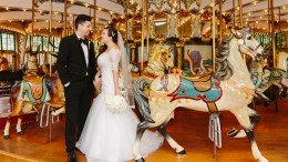 Bride and groom on the carousel at their San Francisco Zoo wedding
